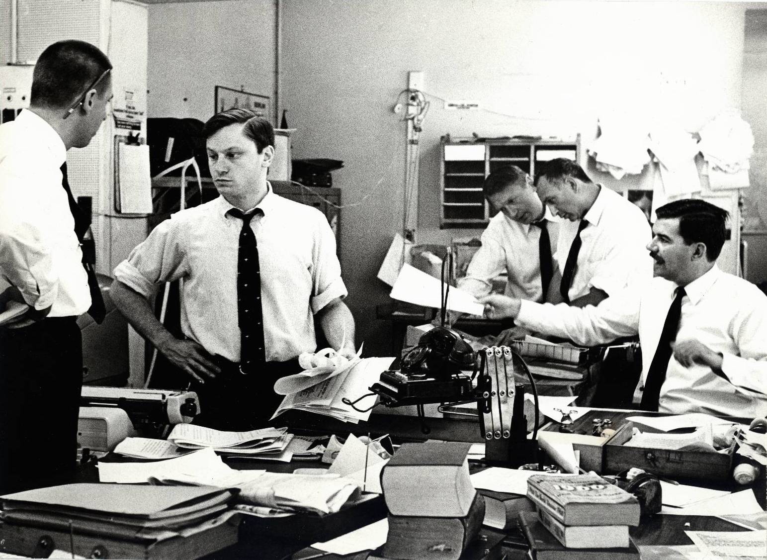 RFE covers the Middle East Crisis -- In the Central News Room of Radio Free Europe Headquarters in Munich, Germany, members of the RFE News Department prepare up-to-the-minute dispatches on the Arab-Israeli war for listeners in East Europe. Pictured from left are Deputy Director Tom Bodin, Editor William Kirtz, News Director Nat Kingsley, Special Events Chief Stephen Steinberg and Editor Jon Powis. June 1967.