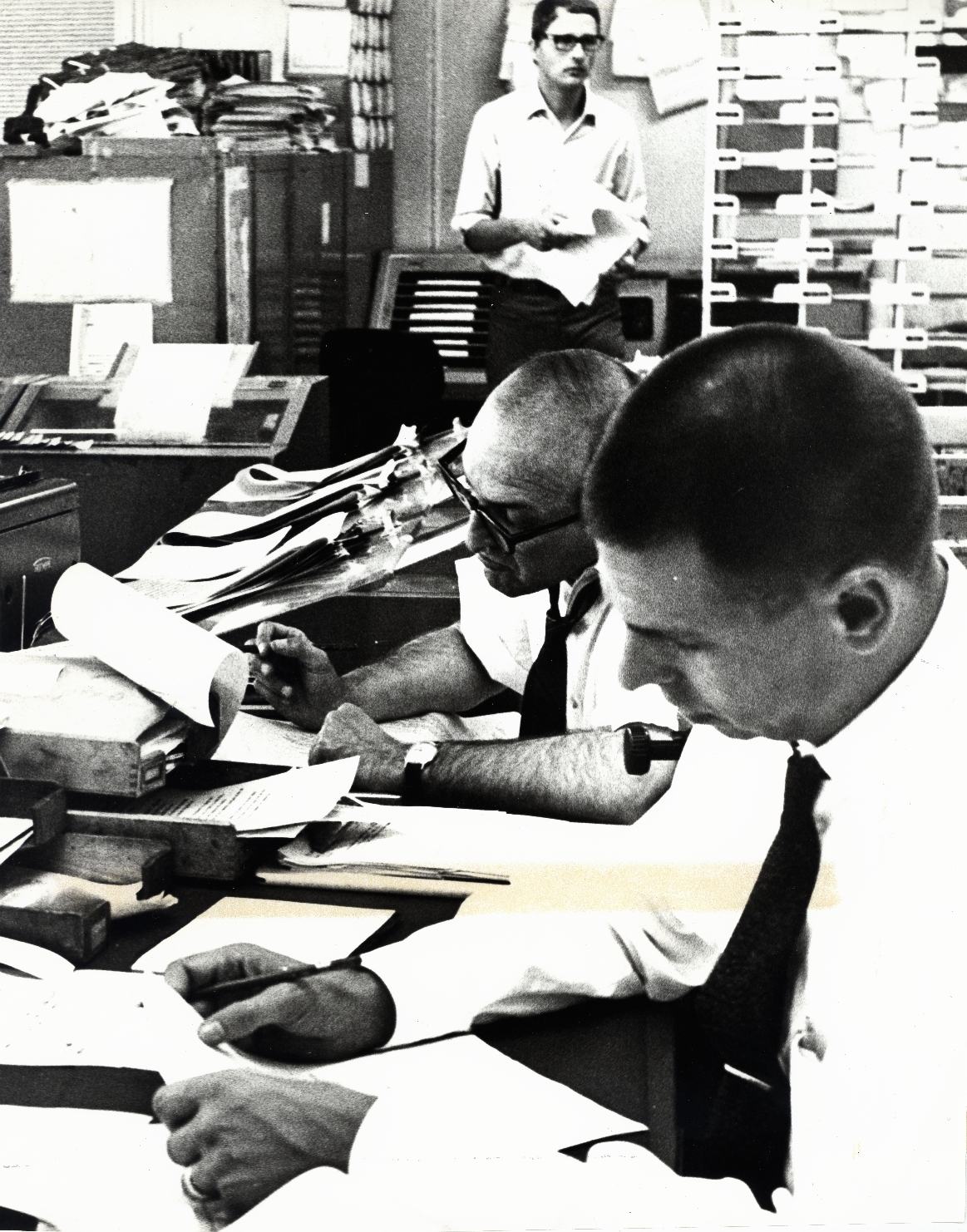 RFE COVERS THE MIDDLE EAST CRISIS -- In the Central News Room of Radio Free Europe headquarters in Munich, Germany, RFE editors examine latest dispatches on the Arab-Israeli war. RFE kept its 22 listeners in East Europe informed with up-to-the-minute bulletins on developments in the conflict. June 1967.